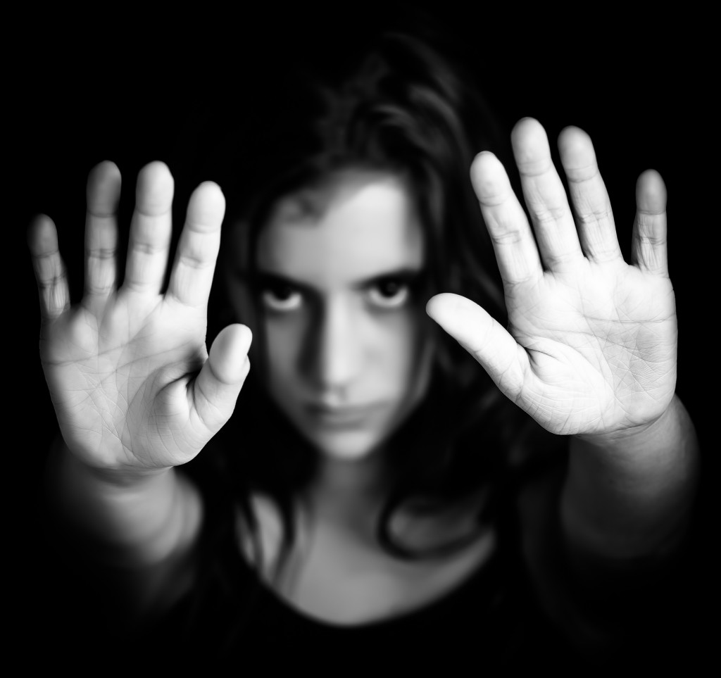 Girl with hands signaling to stop in black and white